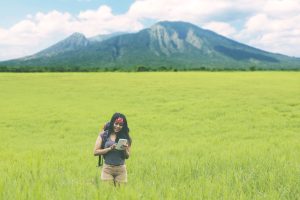 beautiful female hiker looking at the navigation